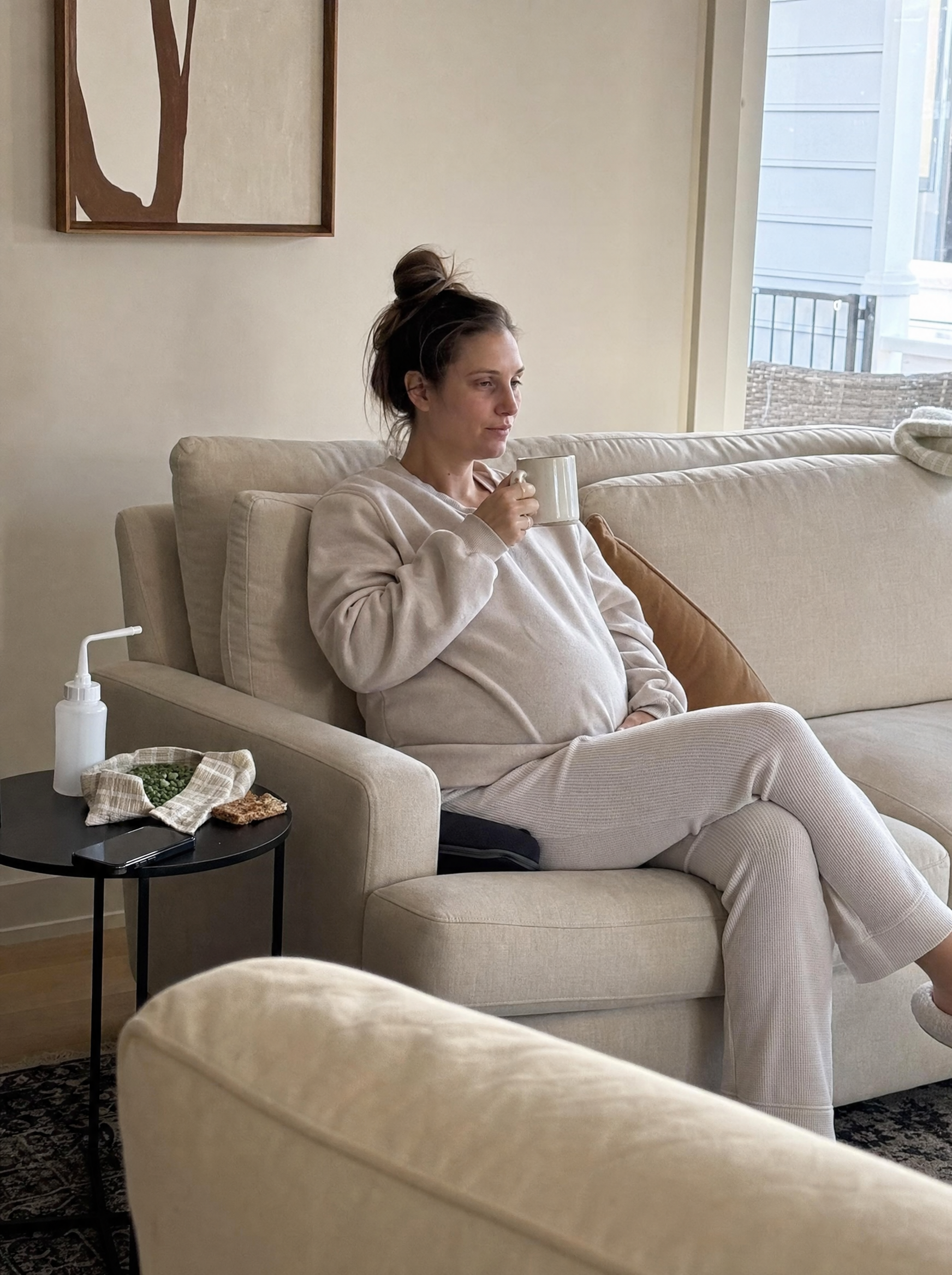 Hannah on the couch two weeks postpartum