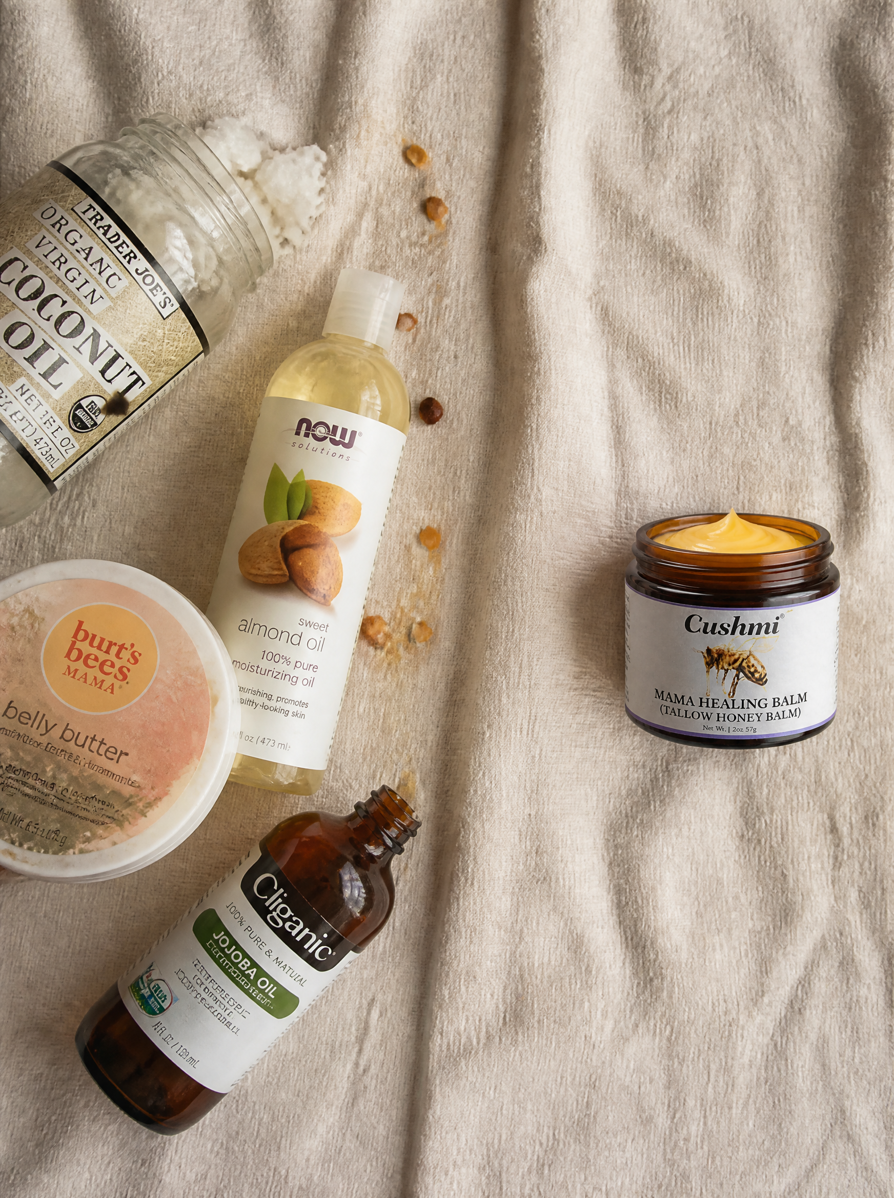 Cluttered pantry oils — coconut oil, almond oil, jojoba, generic pregnancy belly butter