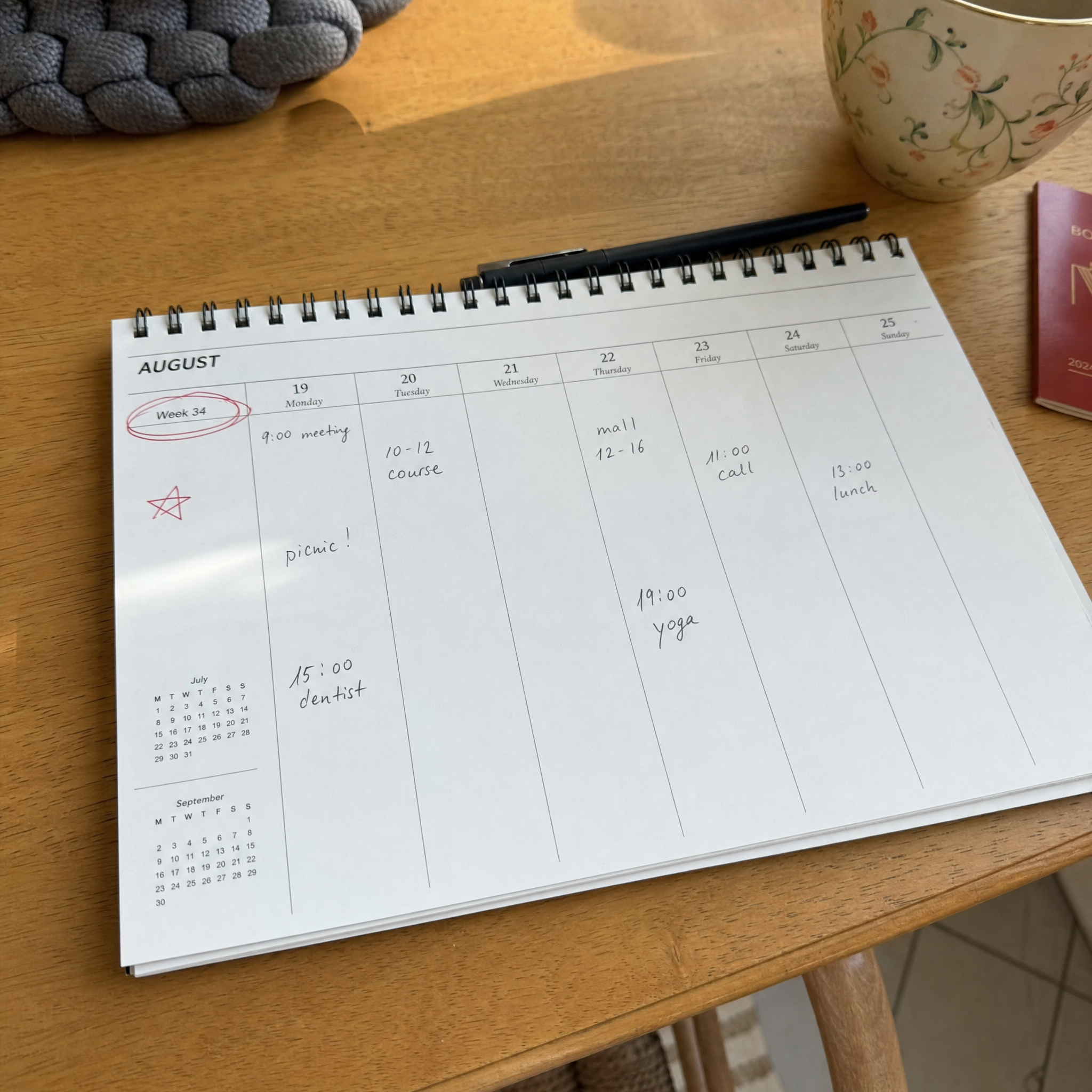 Paper desk calendar with Week 34 circled in red ballpoint pen